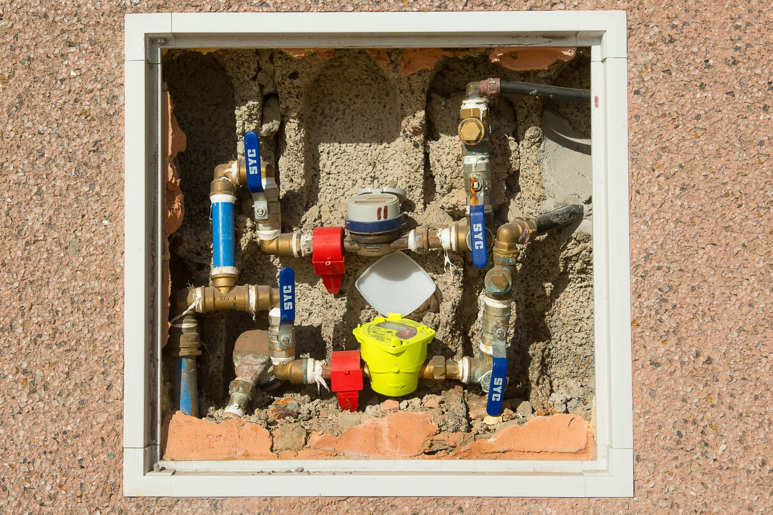 Water meter and valves inside a wall utility box