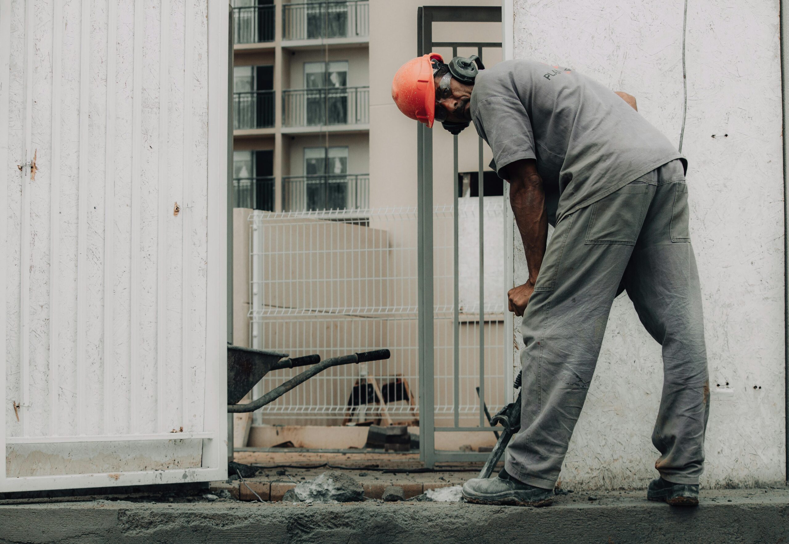Plumber in a hard hat working at an outdoor job site