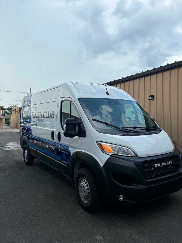 The Flush Club Plumbing work van parked beside a building